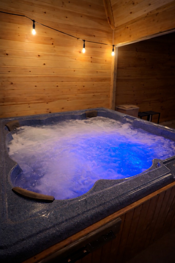 Cozy wood-paneled spa atmosphere with warm lights.